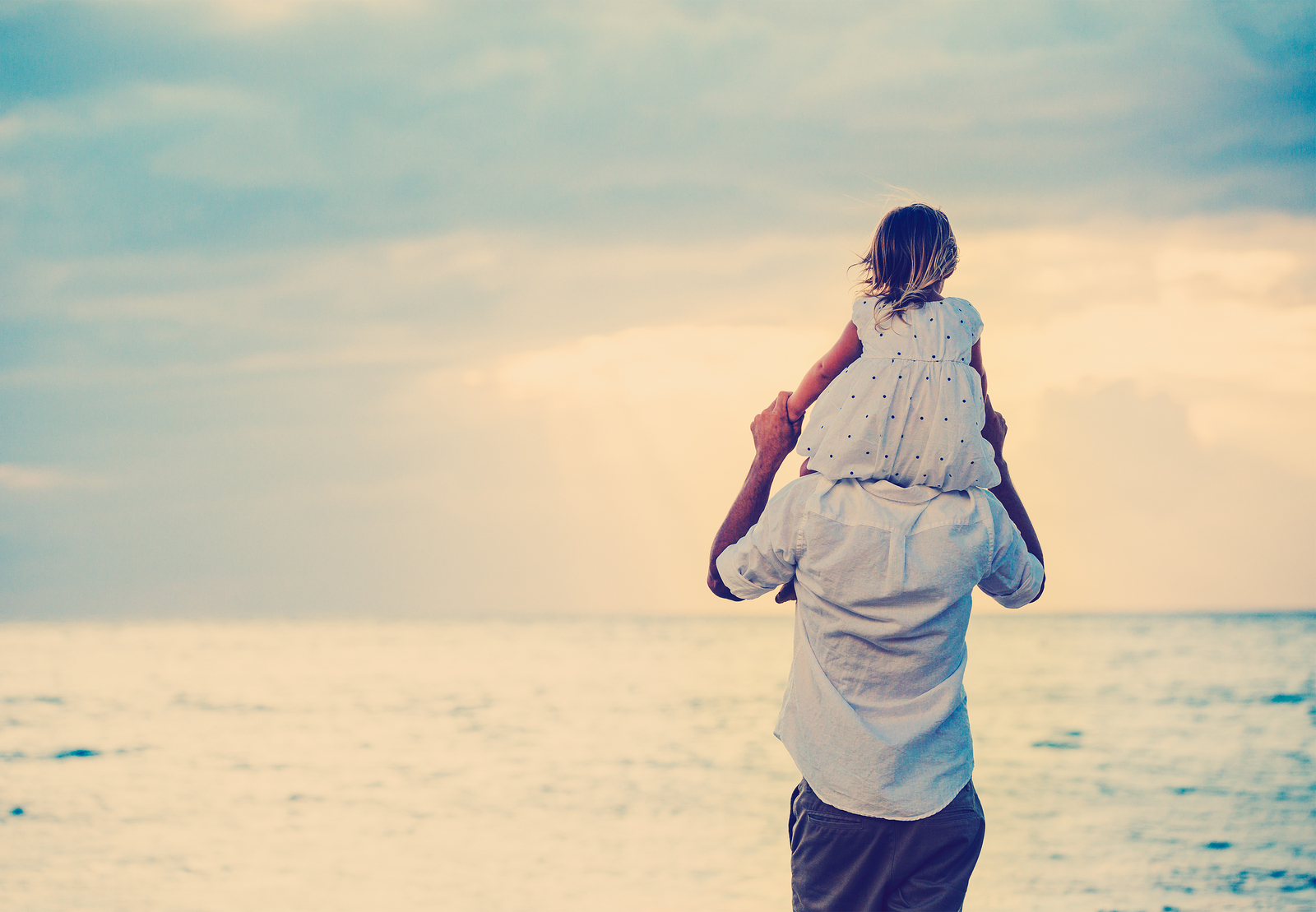 Father and Daughter Playing Together at the Beach at Sunset. Hap