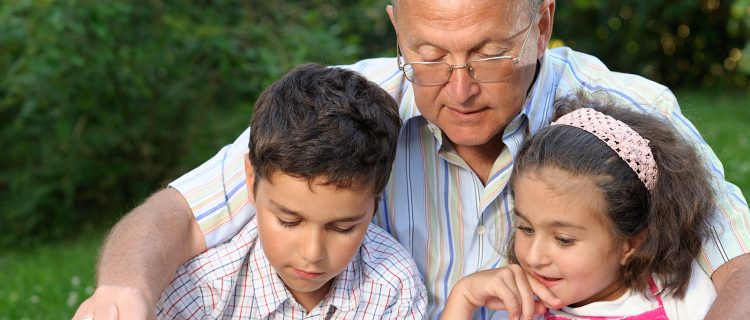 Grandfather And Kids Reading Book