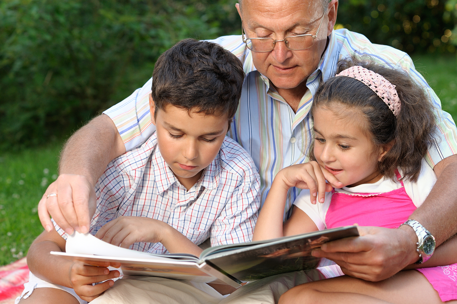 Grandfather And Kids Reading Book