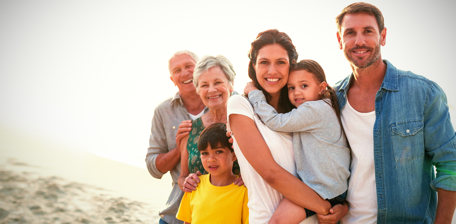 Portrait of happy family standing at beach