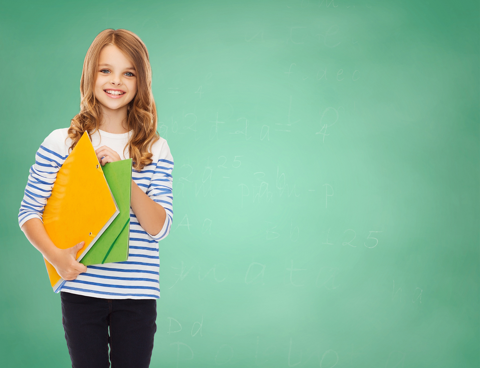 education, people, children and school concept - happy girl holding colorful folders over green board background