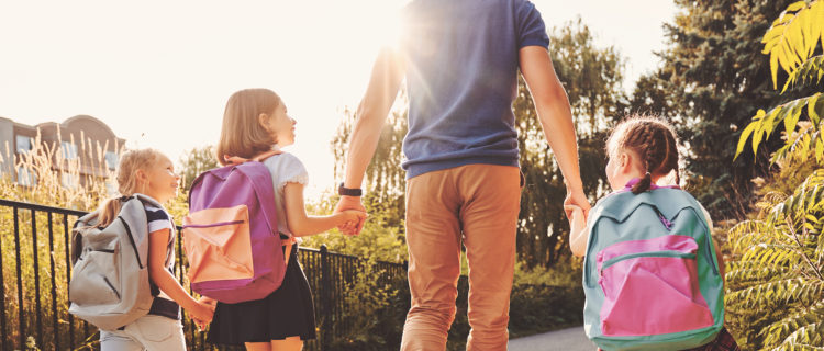 Father walking daughters to school